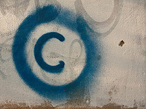 Large copyright graffiti sign on cream colored wall