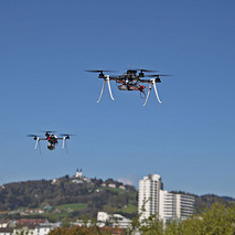 Two "drones" quietly flying over the sky. These are unmanned spacecraft, widely used for surveillance. BY (Ars Electronica) NC - ND